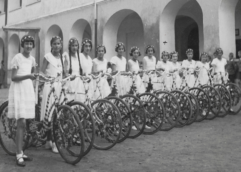 the girls in white dresses and bicycle 573x800
